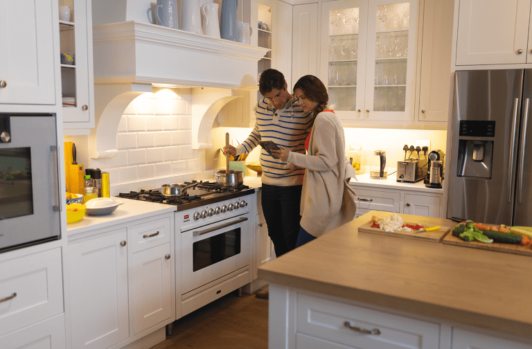 Couple in kitchen with appliances